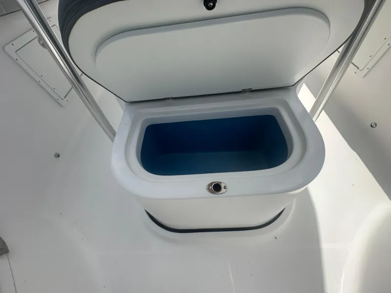 Slide: The Image of Open storage compartment on 2022 Aquasport 2300 boat, featuring a blue interior. - 10