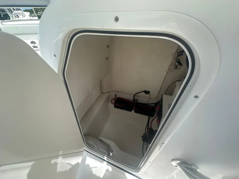 Slide: The Image of Storage compartment of 2022 Aquasport 2300 boat, showing interior wiring and equipment. - 11