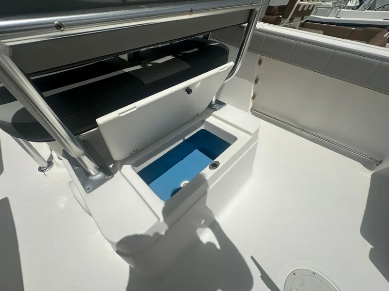 Slide: The Image of 2022 Aquasport 2300 boat interior with open storage compartment. - 13