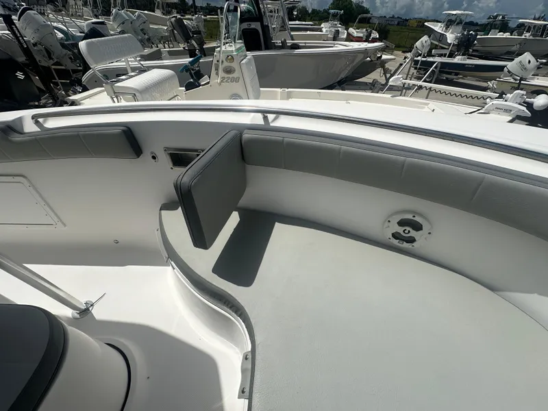 Slide: The Image of 2022 Aquasport 2300 boat interior with cushioned seating and sleek design. - 8