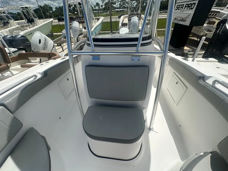 Slide: The Image of 2022 Aquasport 2300 boat interior with seating and console, displayed outdoors. - 9