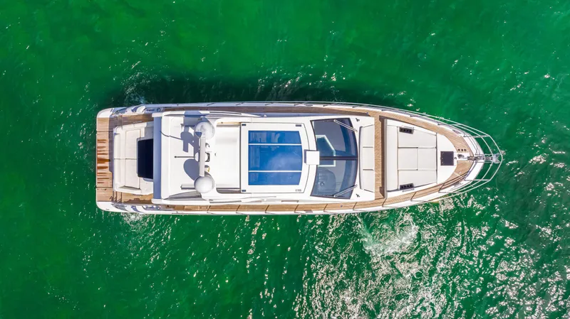 Slide: The Image of Aerial view of a 2016 Azimut 55S yacht cruising in clear green waters. - 15