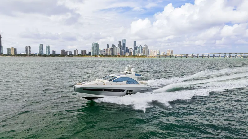 Slide: The Image of 2016 Azimut 55S yacht cruising near a city skyline. - 19