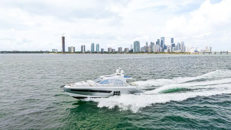 Slide: The Image of 2016 Azimut 55S yacht cruising near a city skyline. - 20