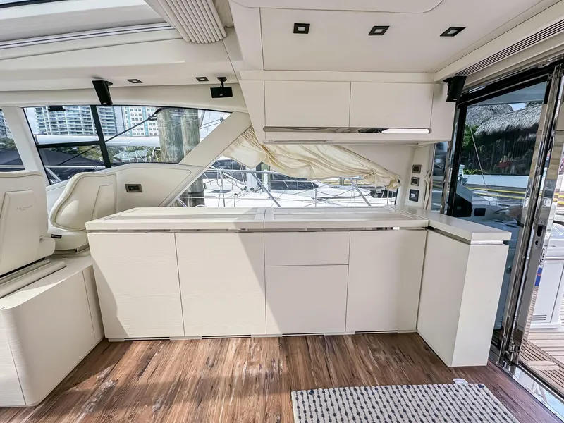 Slide: The Image of Modern interior of 2016 Azimut 55S yacht with sleek white cabinetry and wooden flooring. - 31