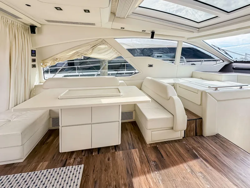 Slide: The Image of Luxurious interior of 2016 Azimut 55S yacht with white seating and wooden flooring. - 34