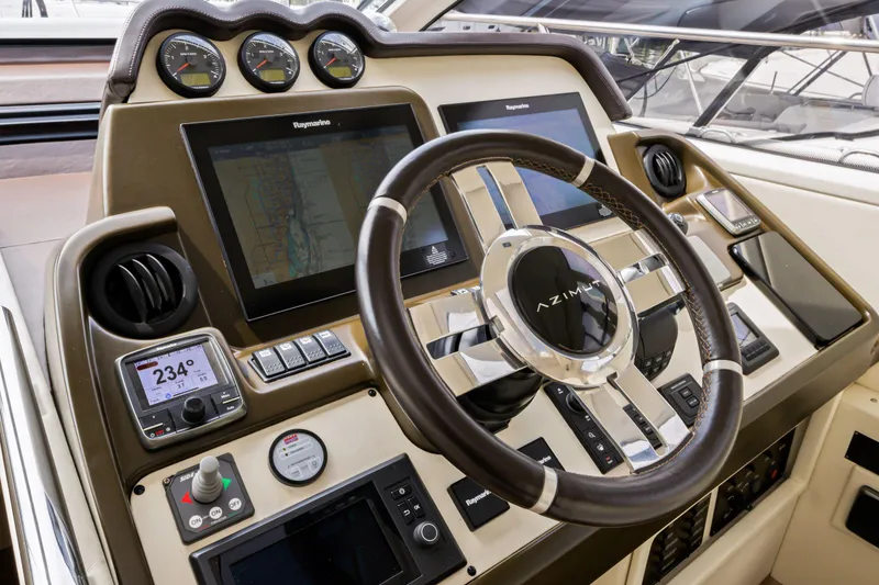 Slide: The Image of Cockpit of 2016 Azimut 55S yacht with advanced navigation systems and steering wheel. - 38