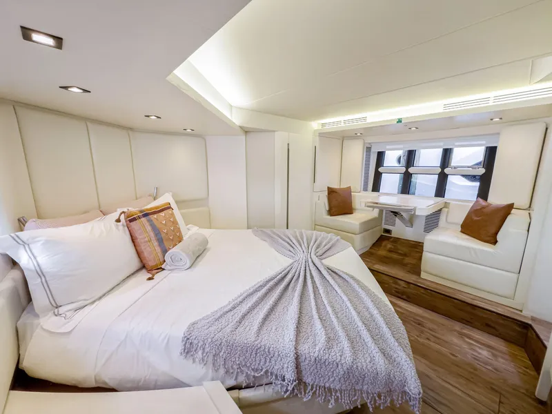 Slide: The Image of Luxurious bedroom interior of 2016 Azimut 55S yacht with modern decor and cozy seating area. - 40