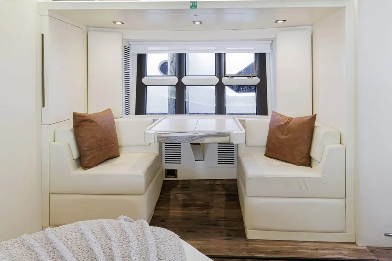 Slide: The Image of Luxurious dining area in 2016 Azimut 55S yacht with white leather seating and wooden flooring. - 43
