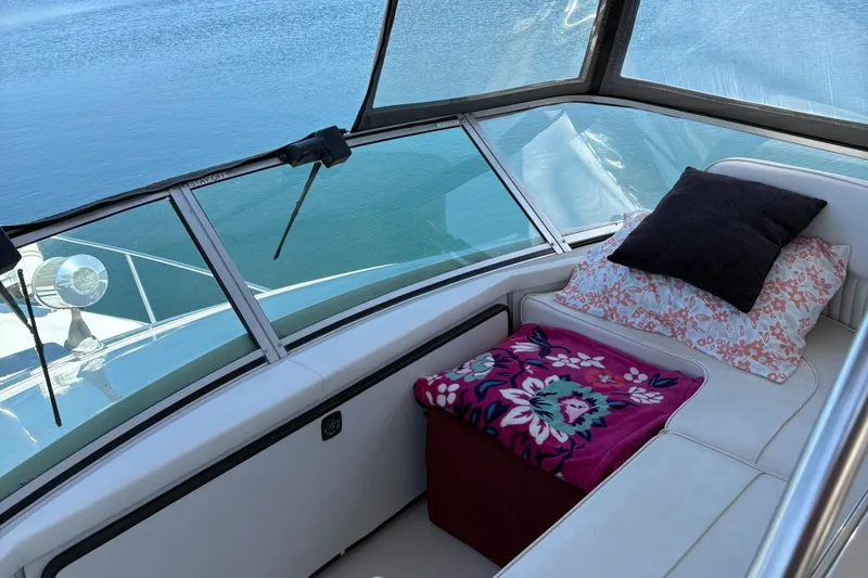 Slide: The Image of Interior of 1987 Sea Ray 460 Convertible with cozy seating and floral cushions. - 11