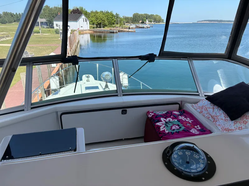 Slide: The Image of 1987 Sea Ray 460 Convertible boat interior with scenic waterfront view. - 12