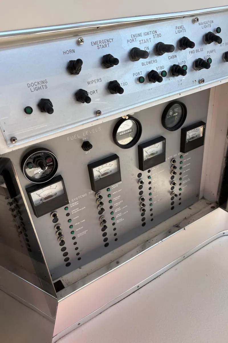 Slide: The Image of Control panel of a 1987 Sea Ray 460 Convertible boat with various switches and gauges. - 15