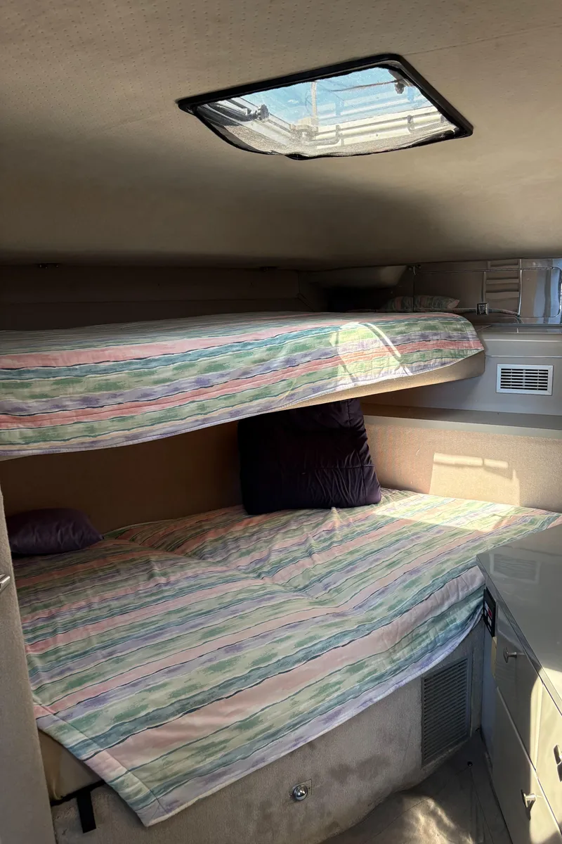 Slide: The Image of Interior cabin of 1987 Sea Ray 460 Convertible with bunk beds and skylight. - 16