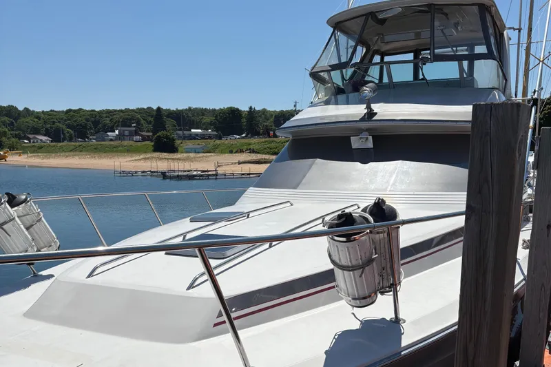 Slide: The Image of 1987 Sea Ray 460 Convertible yacht docked by a scenic shoreline. - 20