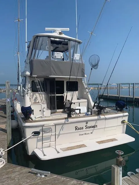 Slide: The Image of 1987 Sea Ray 460 Convertible docked, equipped for fishing, with clear skies in the background. - 27