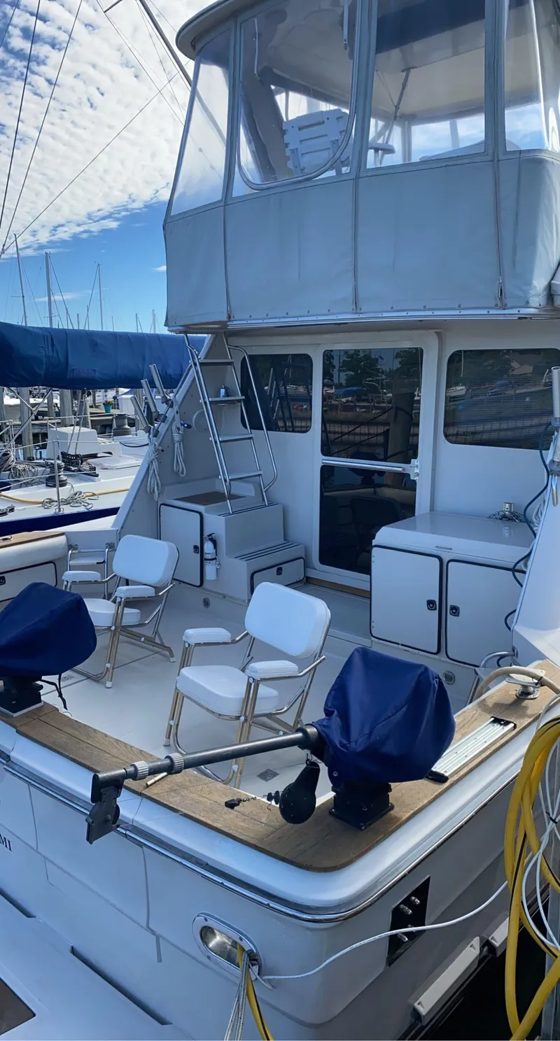 Slide: The Image of 1987 Sea Ray 460 Convertible yacht with outdoor seating and covered upper deck. - 28