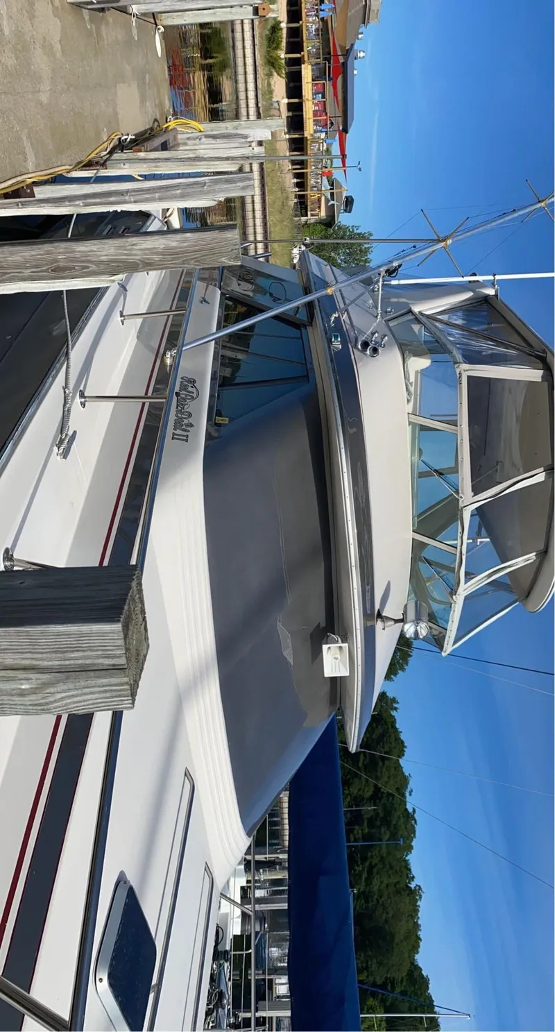 Slide: The Image of 1987 Sea Ray 460 Convertible docked at marina under clear blue sky. - 29