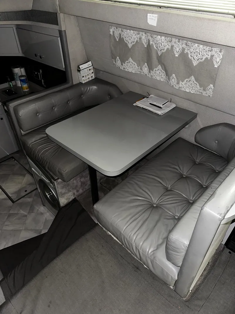 Slide: The Image of 1987 Sea Ray 460 Convertible interior with gray leather seating and dining table. - 33