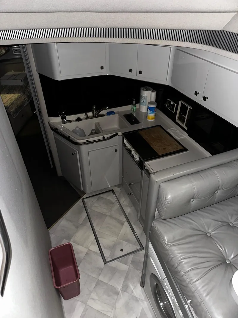 Slide: The Image of Interior of 1987 Sea Ray 460 Convertible yacht with kitchen and seating area. - 34