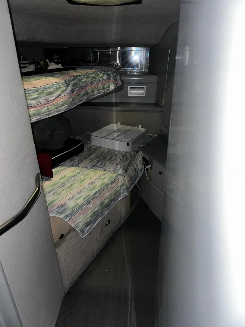 Slide: The Image of 1987 Sea Ray 460 Convertible cabin interior with bunk beds and storage. - 36