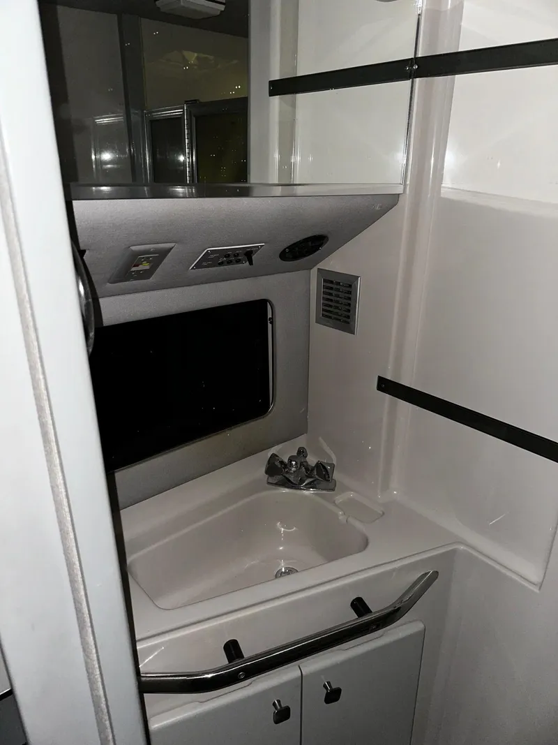 Slide: The Image of 1987 Sea Ray 460 Convertible yacht bathroom with sink and storage cabinets. - 40