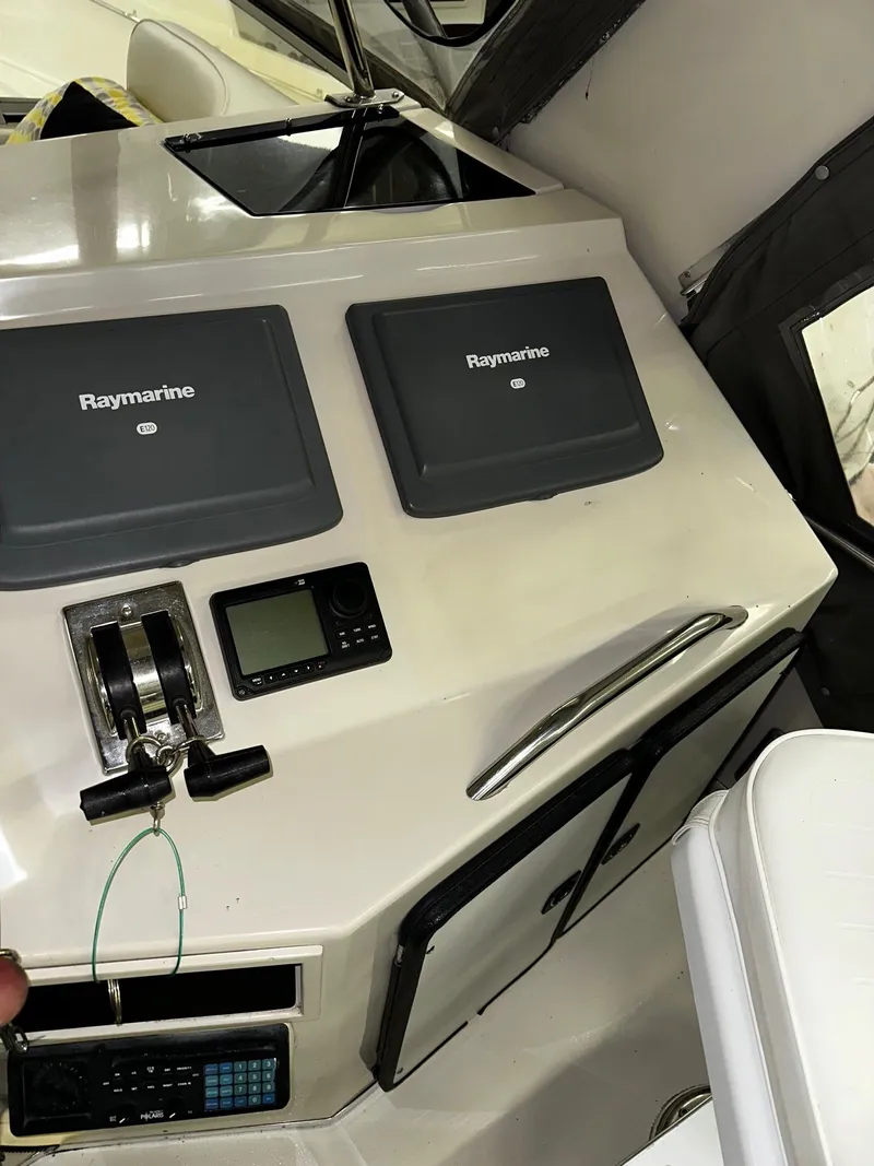 Slide: The Image of Control panel of a 1987 Sea Ray 460 Convertible with Raymarine navigation equipment. - 42