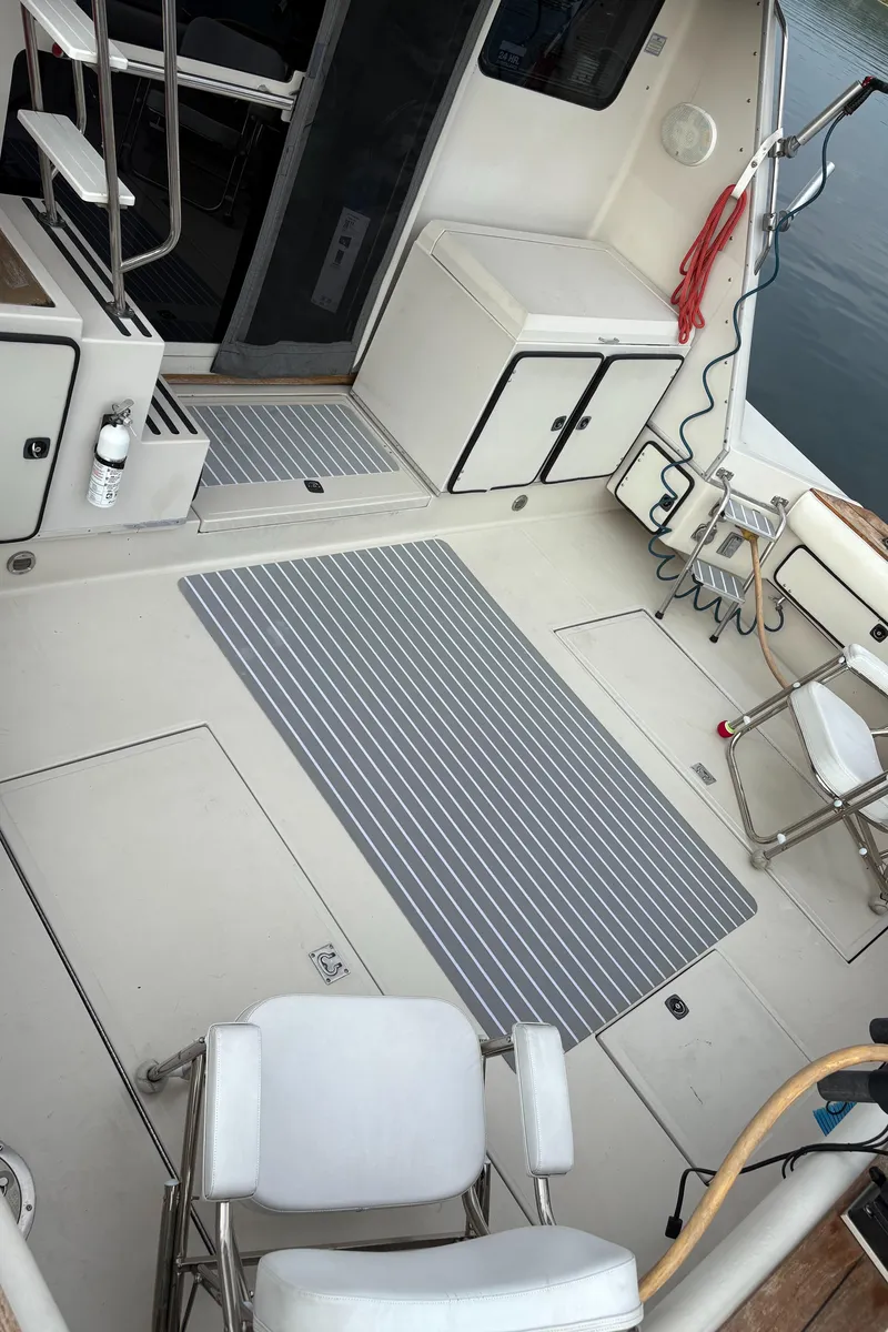 Slide: The Image of 1987 Sea Ray 460 Convertible boat deck with seating, storage, and marine equipment. - 5