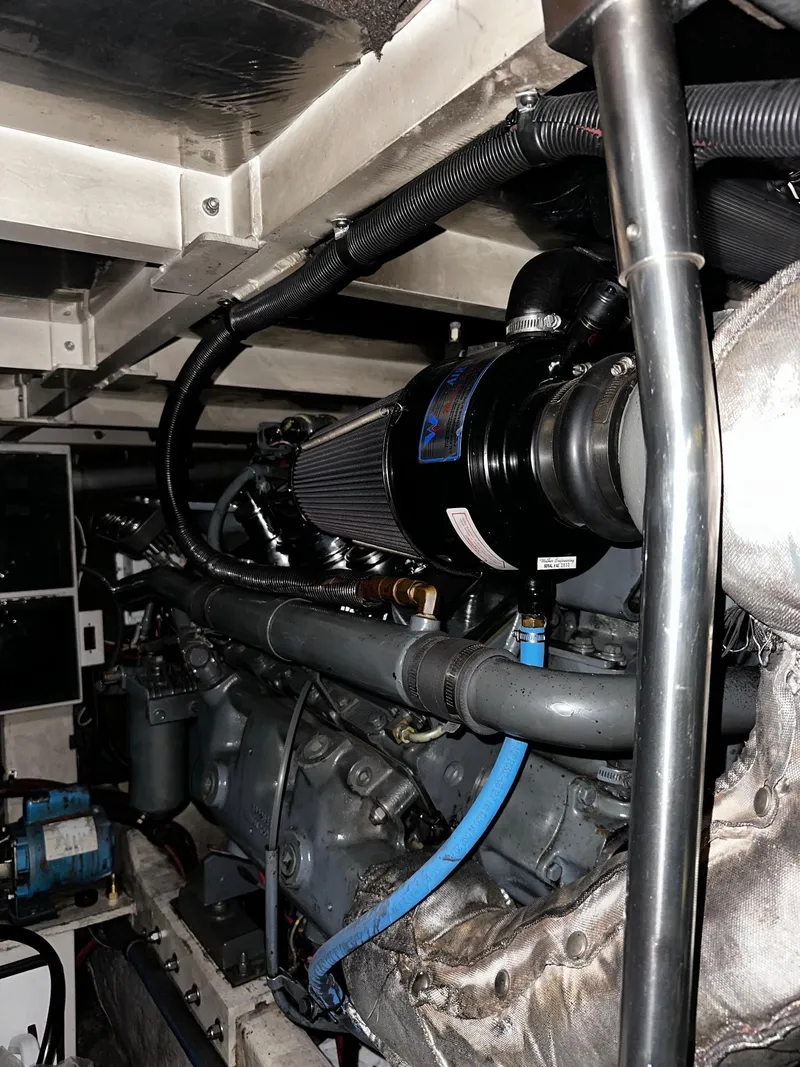 Slide: The Image of Engine room of 1987 Sea Ray 460 Convertible boat, showcasing mechanical components and piping. - 50