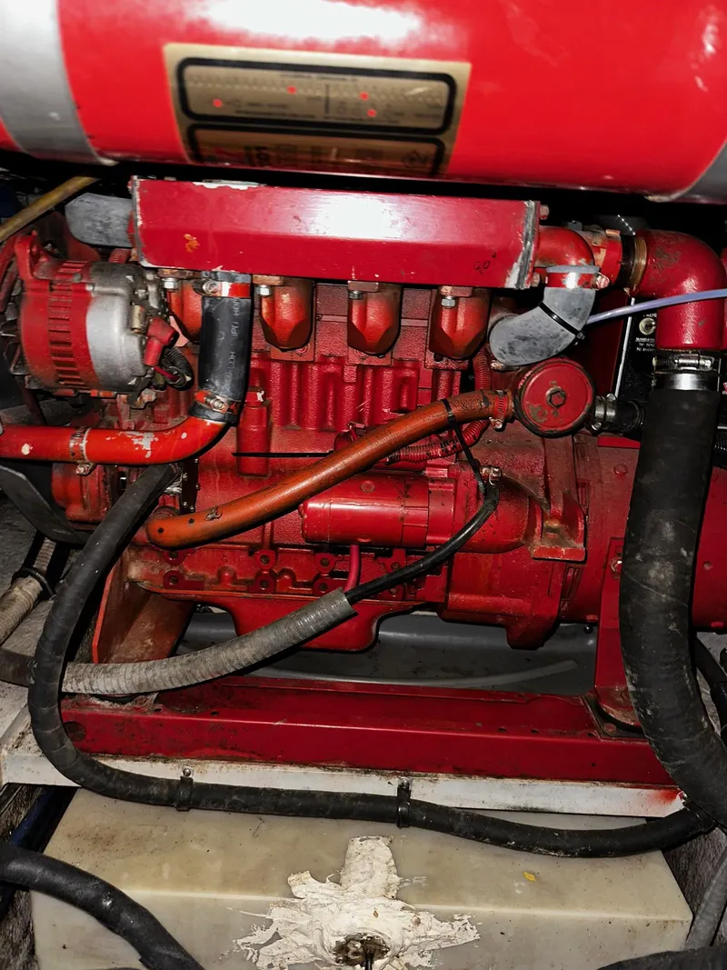 Slide: The Image of Engine of 1987 Sea Ray 460 Convertible, featuring red components and visible hoses. - 51