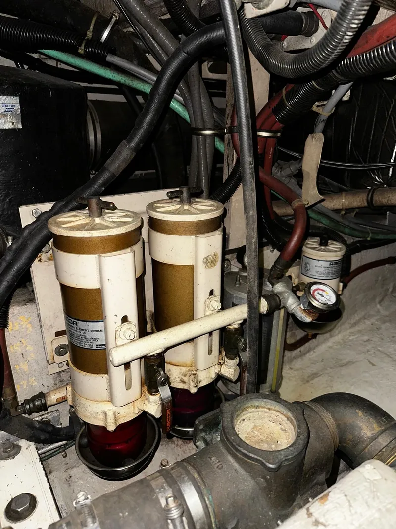 Slide: The Image of Engine compartment of a 1987 Sea Ray 460 Convertible with fuel filters and hoses. - 52