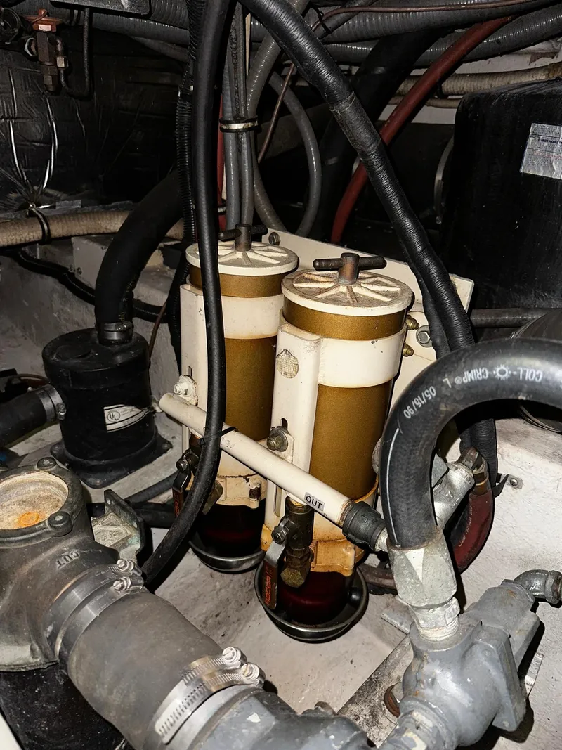 Slide: The Image of Engine compartment of a 1987 Sea Ray 460 Convertible with fuel filters and hoses. - 53