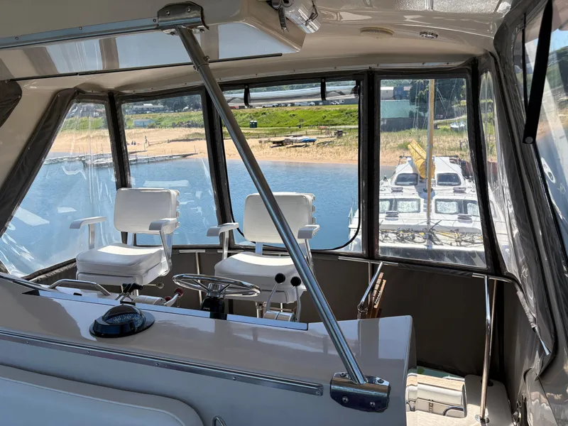 Slide: The Image of Interior view of 1987 Sea Ray 460 Convertible yacht with helm and seating. - 9