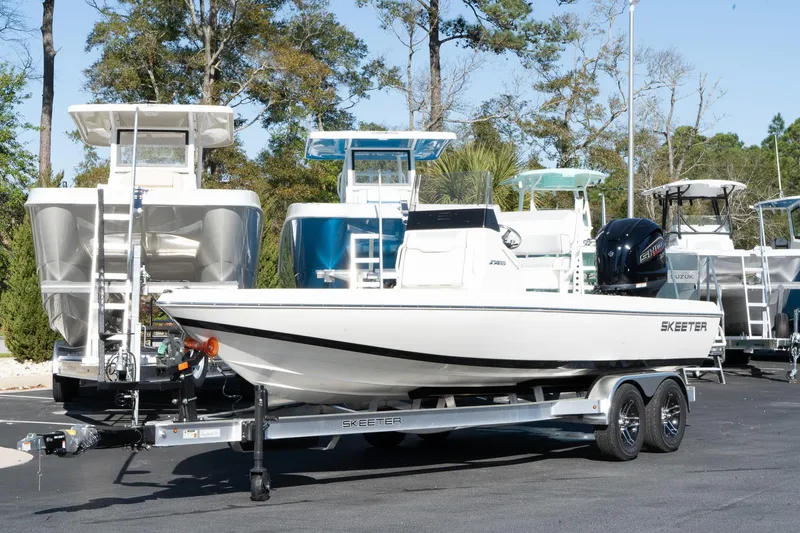 The Image of 2024 Skeeter SX 210 boat on a trailer in a marina. - 1