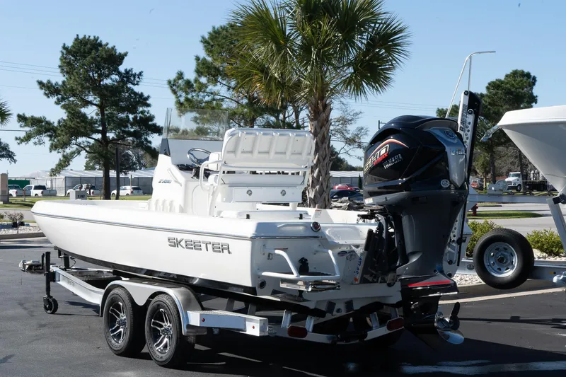 Slide: The Image of 2024 Skeeter SX 210 boat on a trailer, parked outdoors. - 3