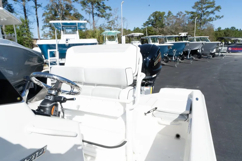 Slide: The Image of 2024 Skeeter SX 210 boat interior with steering wheel and seating. - 8