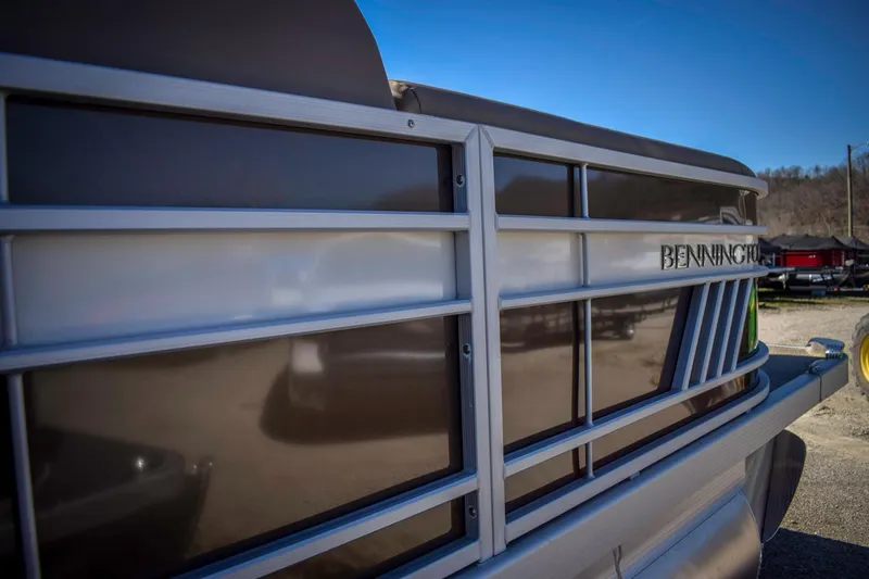 Slide: The Image of 2024 Bennington 22 LSB pontoon boat, sleek design, side view. - 14