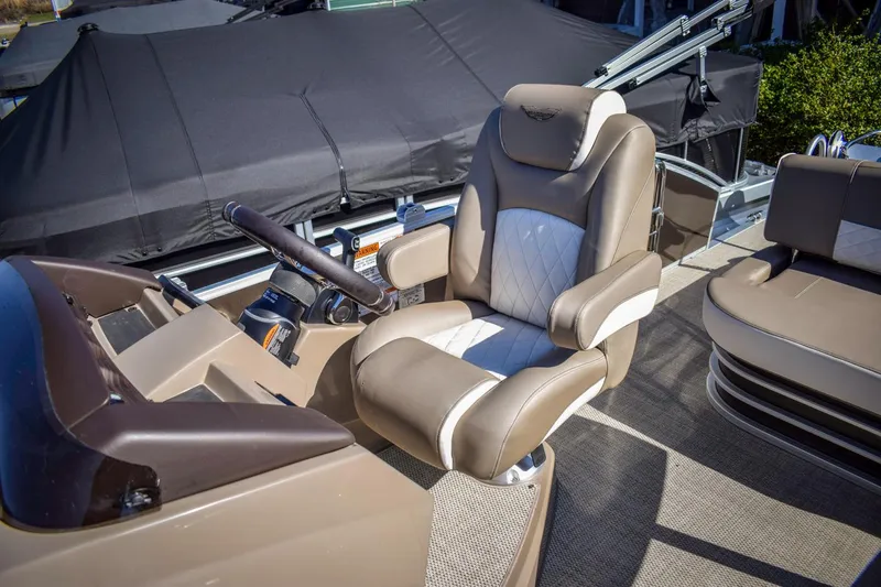 Slide: The Image of 2024 Bennington 22 LSB boat captain's chair and helm, featuring luxurious seating. - 4