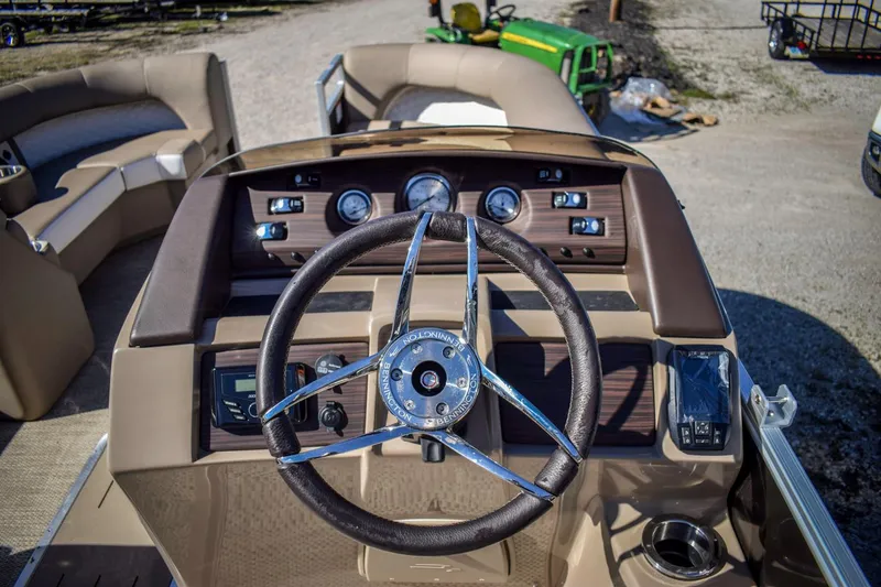 Slide: The Image of 2024 Bennington 22 LSB boat dashboard with steering wheel and gauges. - 6