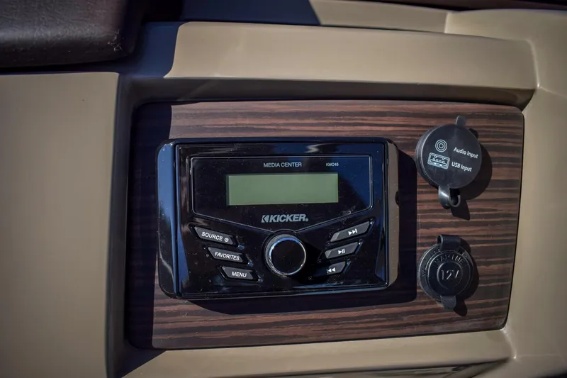 Slide: The Image of 2024 Bennington 22 LSB boat dashboard with Kicker media center and power outlets. - 8