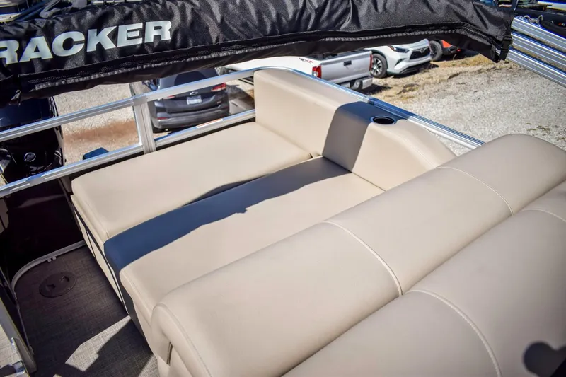 Slide: The Image of 2023 Sun Tracker Sportfish 24 XP3 boat with beige seating and cup holder. - 14