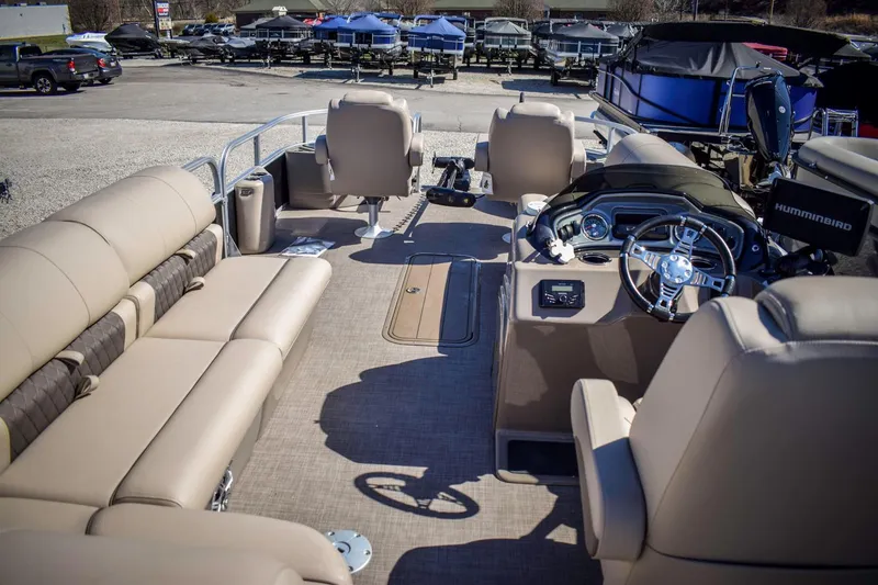 Slide: The Image of 2023 Sun Tracker Sportfish 24 XP3 pontoon boat interior with beige seating and modern dashboard. - 16