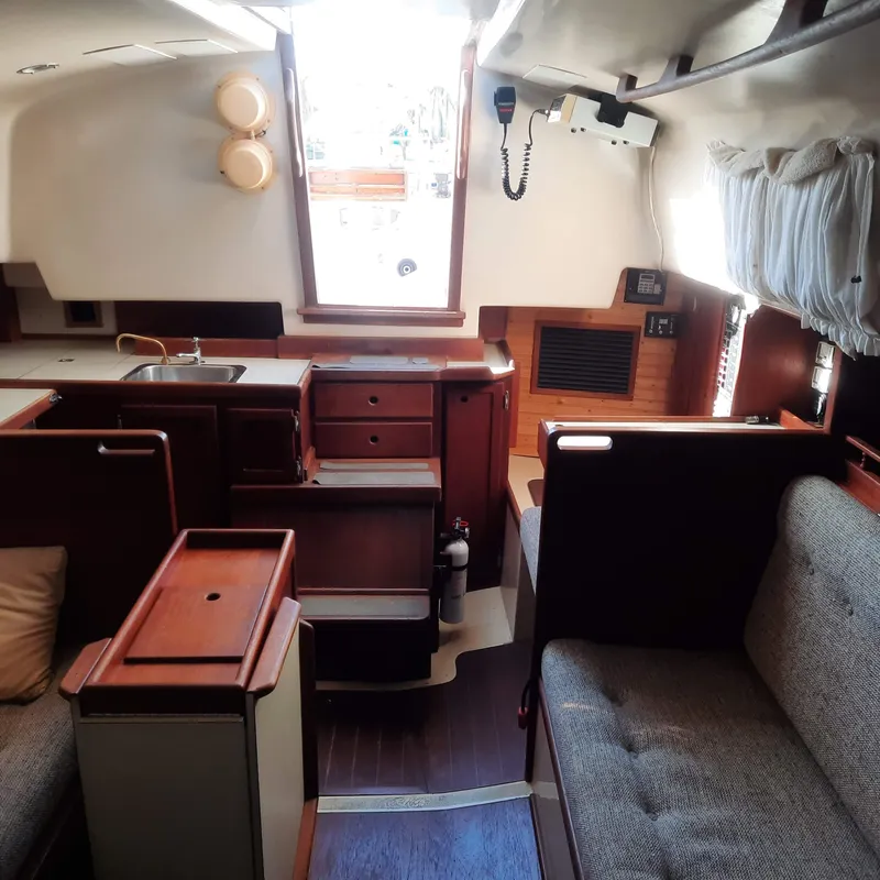 Slide: The Image of Interior of 1984 Bayfield 32C sailboat with wooden cabinetry and seating area. - 6