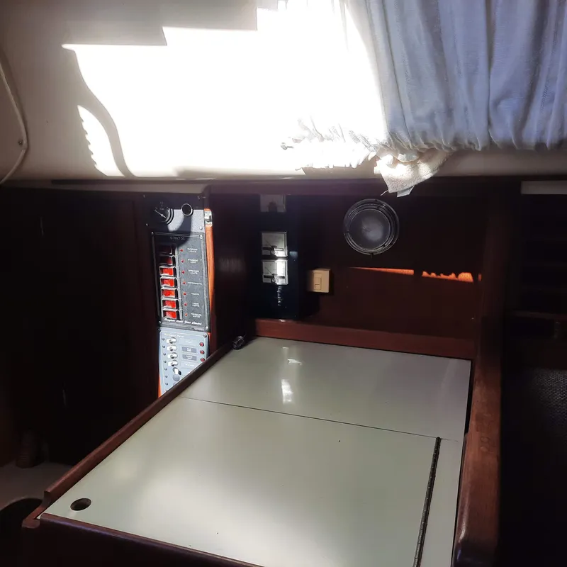 Slide: The Image of Interior of a 1984 Bayfield 32C sailboat showing navigation station and electrical panel. - 7