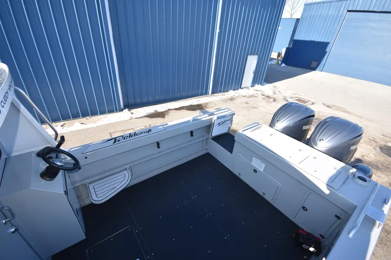 Slide: The Image of Weldcraft 280 Cuddy King 2025 boat with twin outboard motors in a marina. - 15