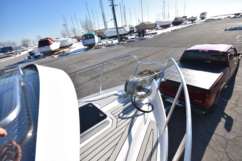 Slide: The Image of 2025 Weldcraft 280 Cuddy King T250XCB boat on trailer in marina parking lot. - 4