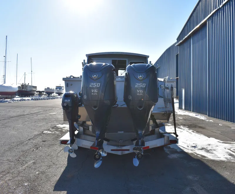 Slide: The Image of 2025 Weldcraft 280 Cuddy King T250XCB boat with twin 250 V6 engines at a marina. - 7