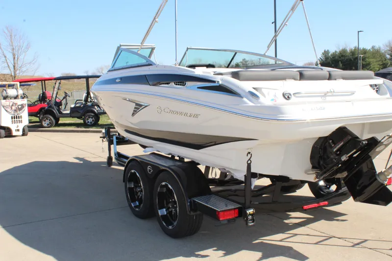 Slide: The Image of 2024 Crownline 220 SS boat on a trailer, ready for transport. - 17