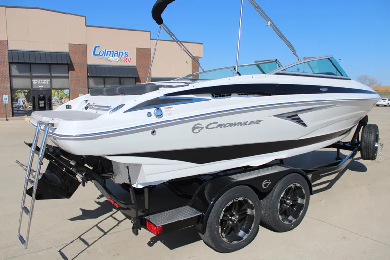 Slide: The Image of 2024 Crownline 220 SS boat on a trailer outside a dealership. - 18