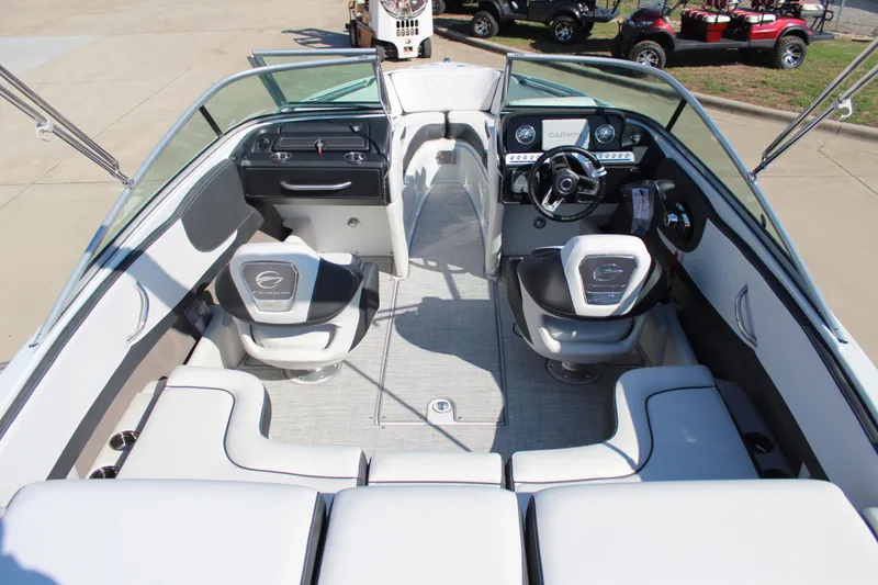 Slide: The Image of 2024 Crownline 220 SS boat interior with modern dashboard and seating. - 2