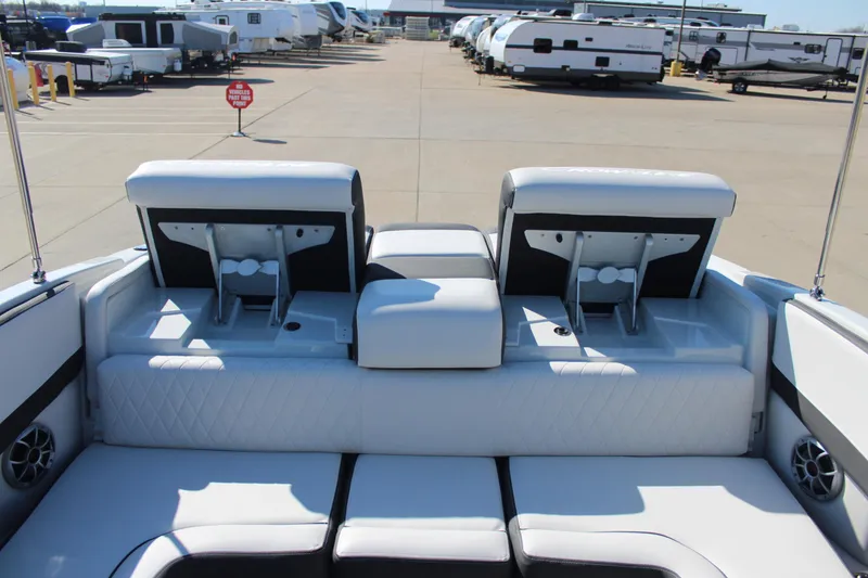 Slide: The Image of 2024 Crownline 220 SS boat interior with white seating and storage compartments. - 8
